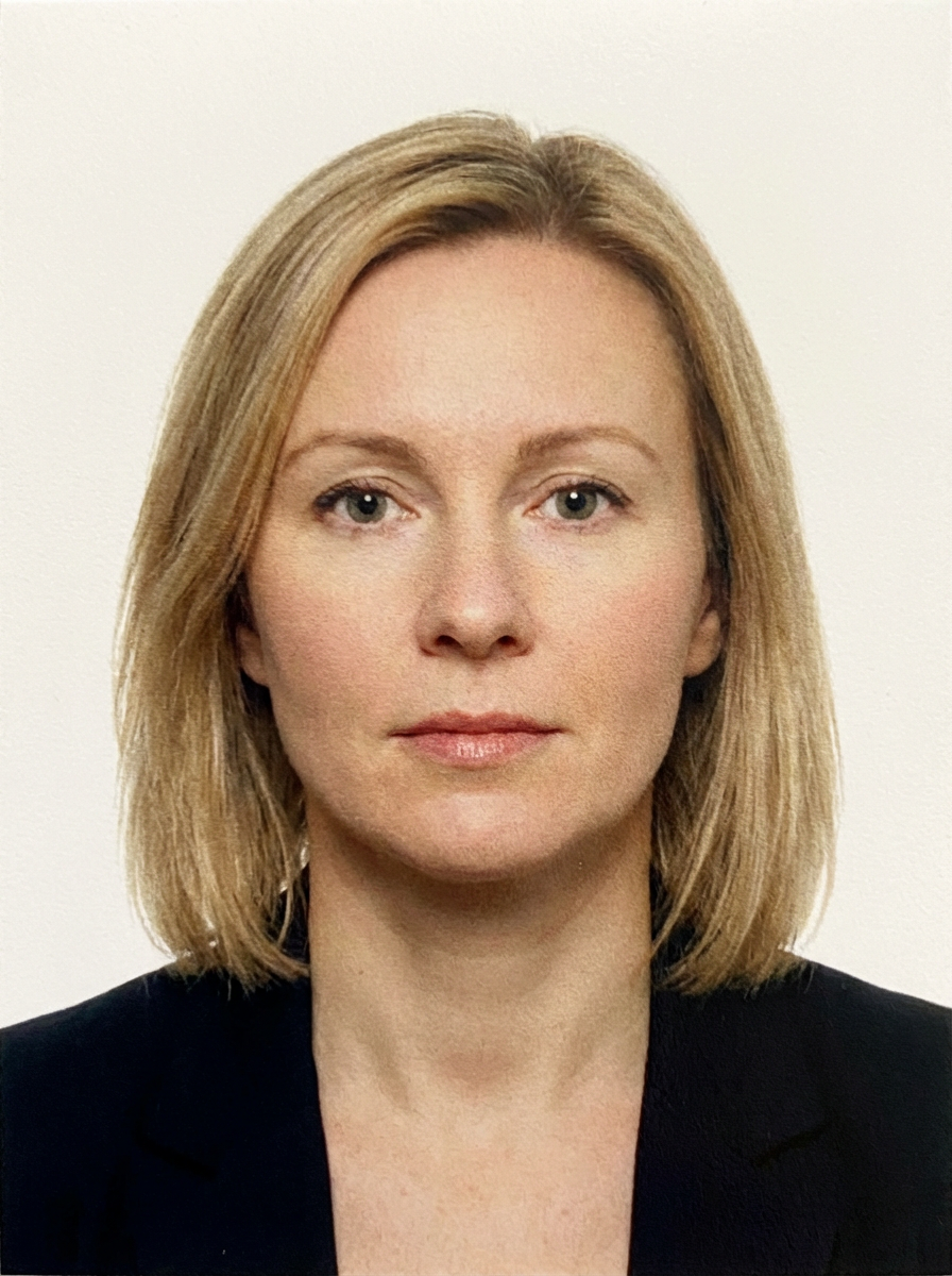 Professional headshot of a woman with blonde hair wearing a black blazer.